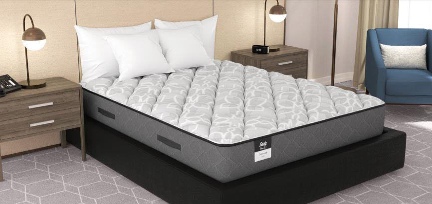 Valiant Products Sealy Posturepedic Dunmore soft mattress with grey knit fabric and side handles in a hotel room
