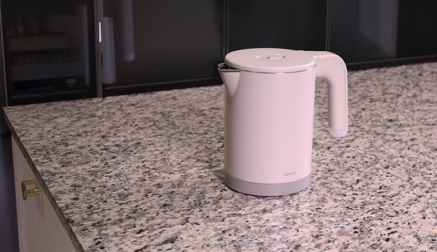 Valiant Products K-608 electric kettle in grey with a 0.8L capacity and anti-scalding design on a granite countertop.