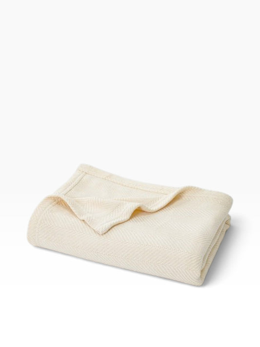 Valiant Products Atelier Luxe natural cotton and TENCEL Modal blanket featuring an elegant herringbone weave design.