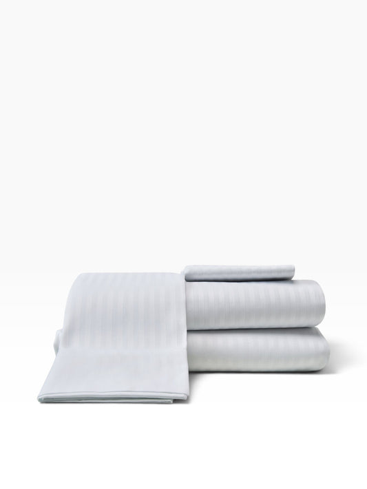 Valiant Products white damask stripe pillowcases in a 310 thread count cotton-polyester blend for luxury hotels.