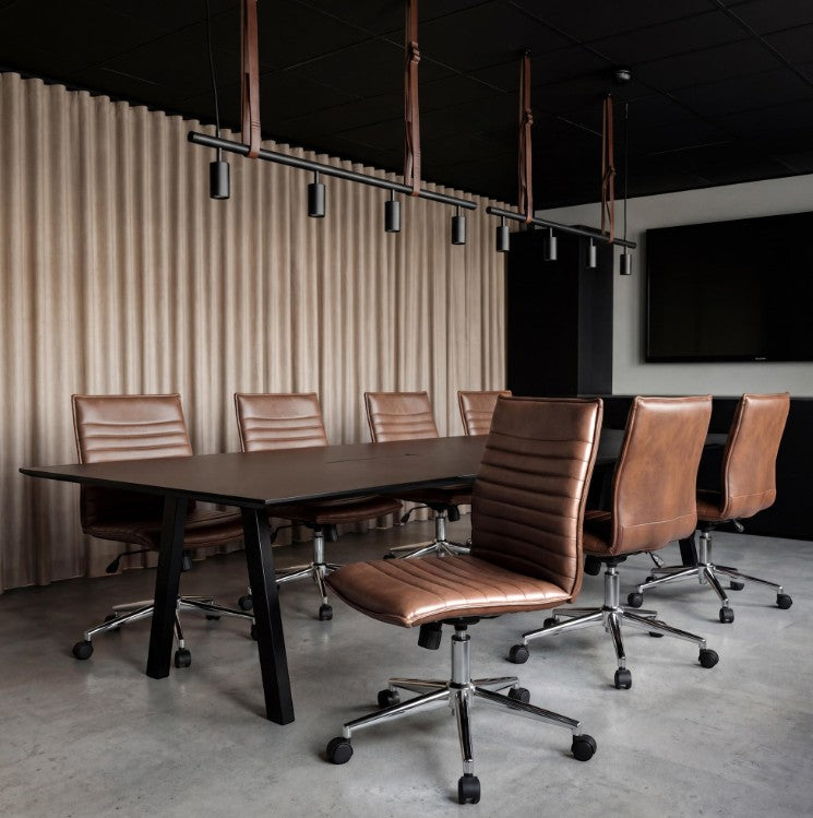 Valiant Products armless ergo chairs with brown PVC vinyl upholstery and chrome bases in a modern conference room