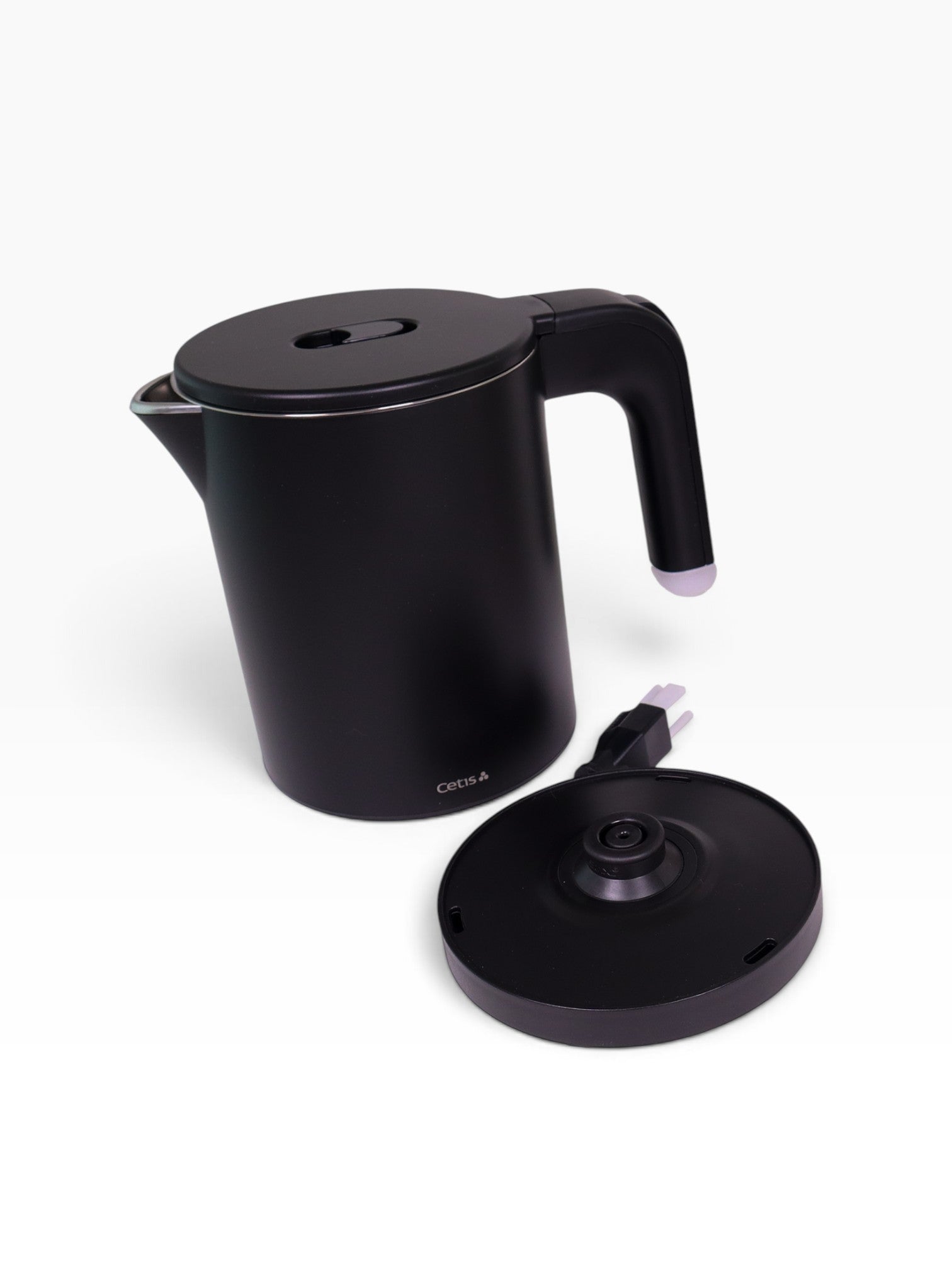 Valiant Products K-608 black electric kettle with anti-scalding insulation and a separate circular power base.