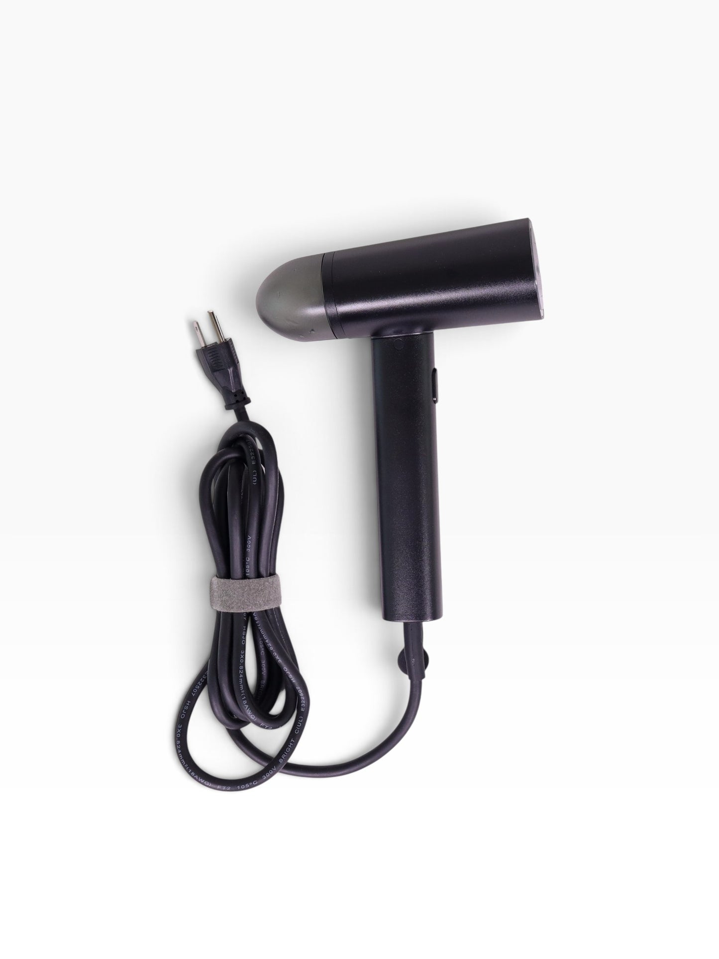 Valiant Products black handheld garment steamer with a compact design, non-stick base plate, and integrated power cord.