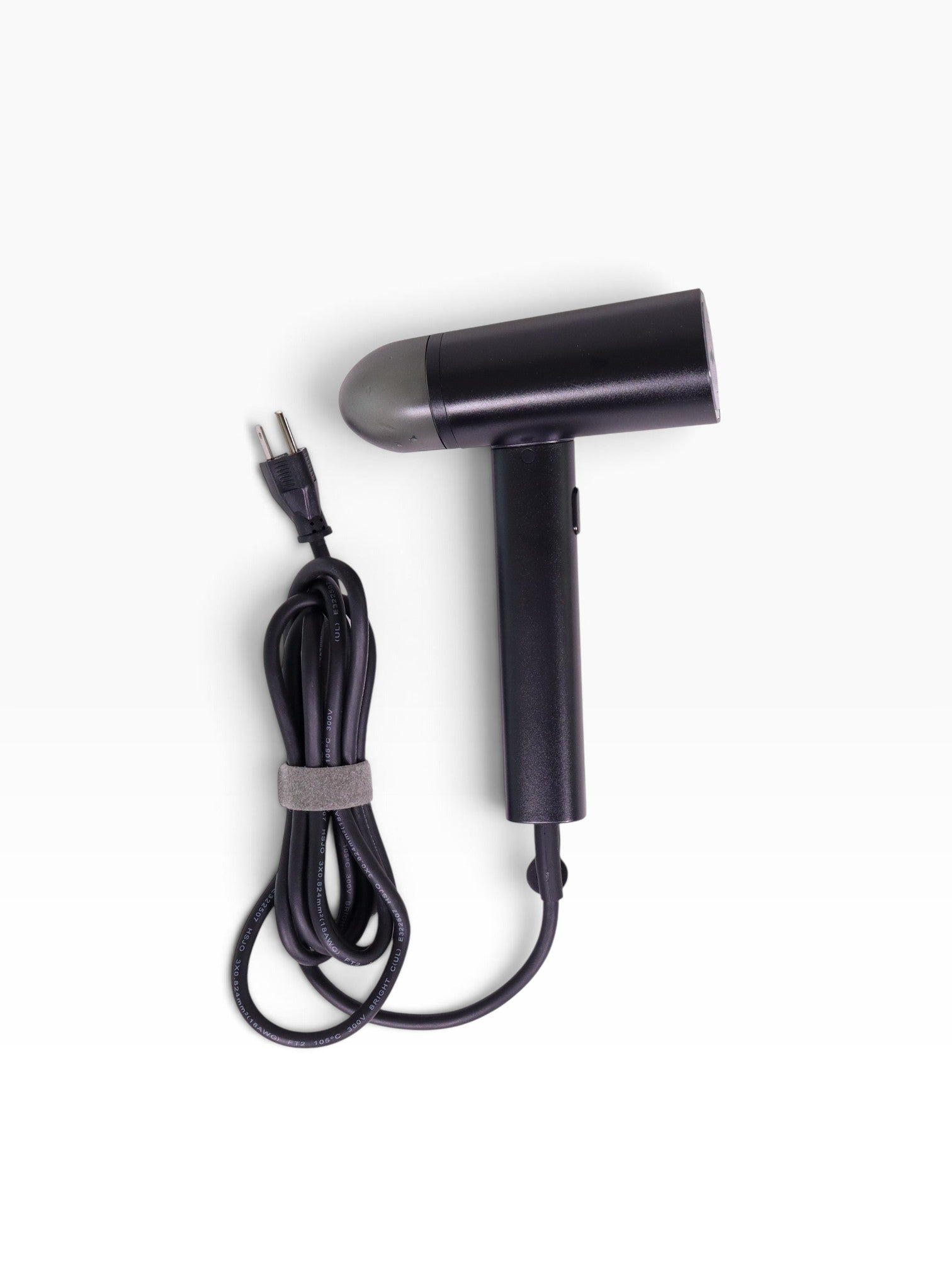 Valiant Products black handheld garment steamer with a compact design, non-stick base plate, and integrated power cord.