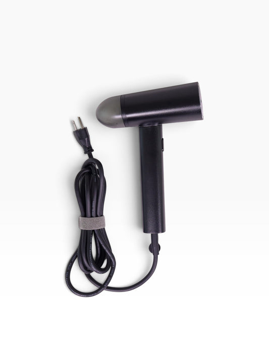 Valiant Products black handheld garment steamer with a compact design, non-stick base plate, and integrated power cord.