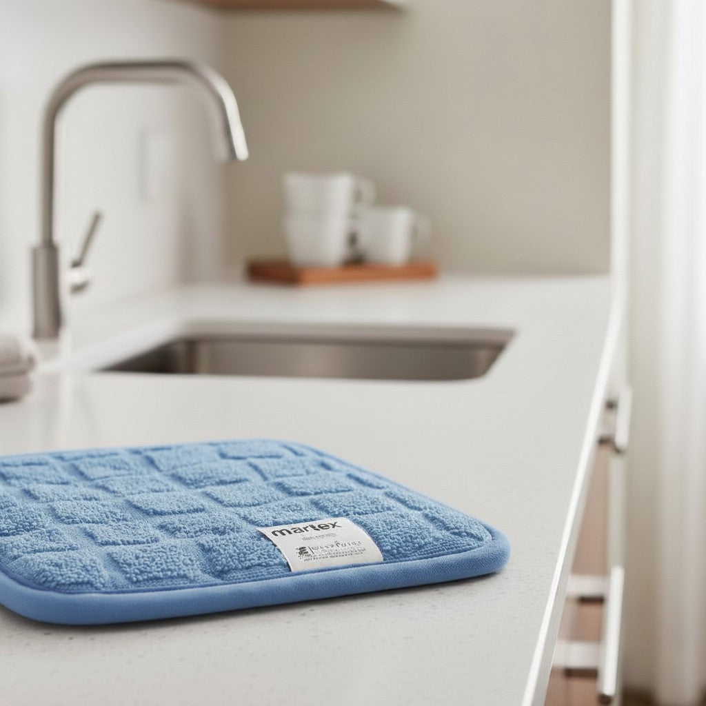 Valiant Products blue square cotton pot holder with a textured grid pattern resting on a modern kitchen countertop.