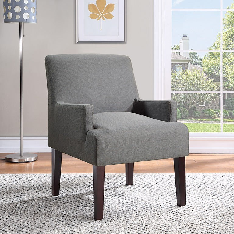Valiant Products Bombo lounge chair in charcoal fabric with espresso wooden legs in a bright living room setting.