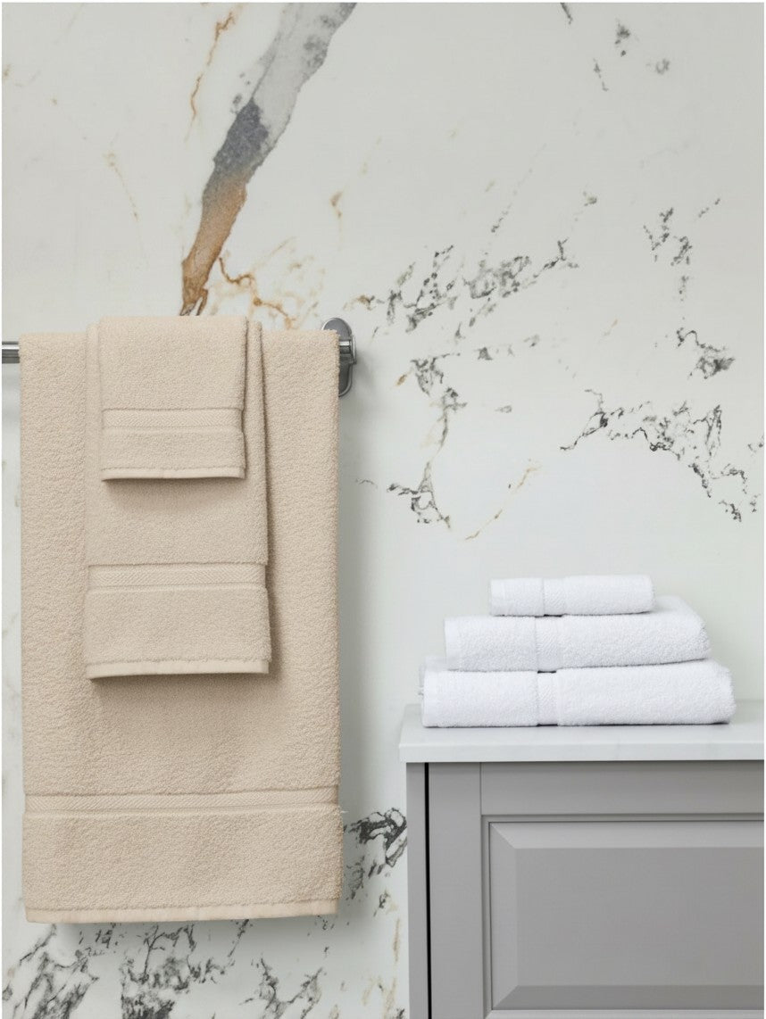Valiant Products Brentwood dobby border towels in ecru and white cotton displayed in a luxury bathroom setting