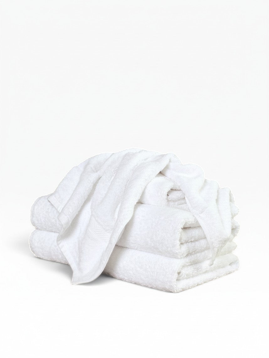 Valiant Products Brentwood white ring-spun cotton washcloths with a dobby border, stacked for hospitality use.