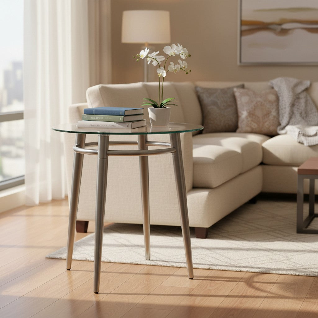 Valiant Products Brooklyn round end table with clear glass top and brushed nickel metal legs in a living room.