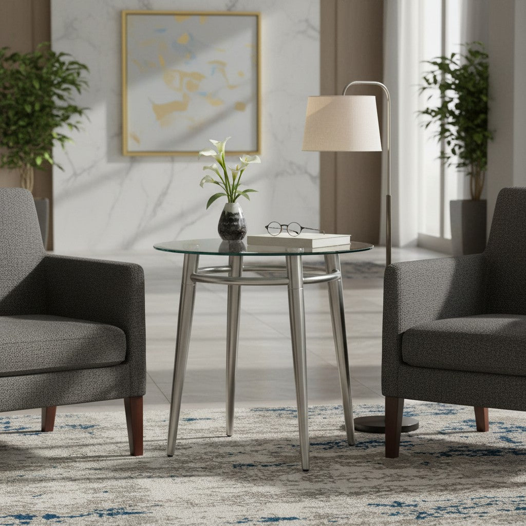 Valiant Products Brooklyn round glass end table with brushed nickel metal legs in a modern living room setting.