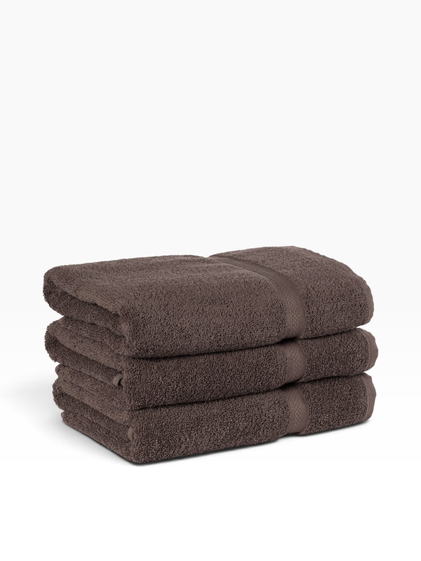 Valiant Products brown ring-spun cotton washcloths stacked with a decorative dobby border design.