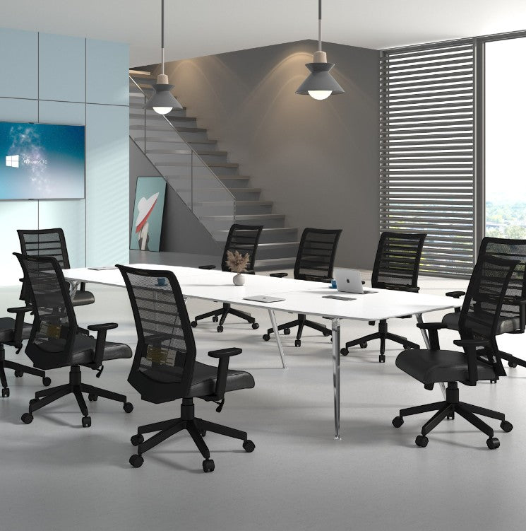 Valiant Products Chisum mesh back ergonomic office chairs arranged around a white conference table in a modern office.