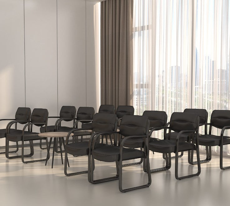 Valiant Products Conrad black leather guest chairs with sled bases arranged in a modern office meeting room setting.