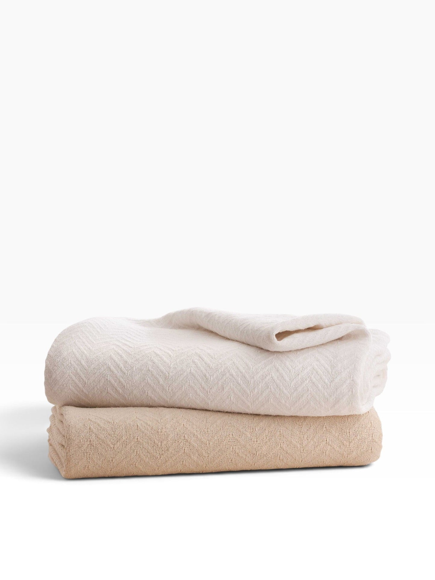 Valiant Products Grand Patrician 100% cotton blankets in white and natural with a classic herringbone weave pattern.