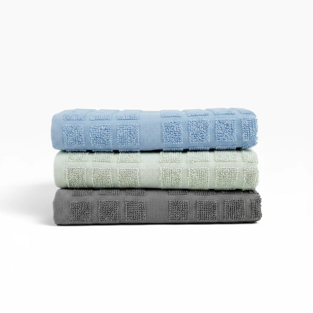 Valiant Products kitchen towels in blue, khaki, and grey, made from fade-resistant ring spun cotton with textured loops