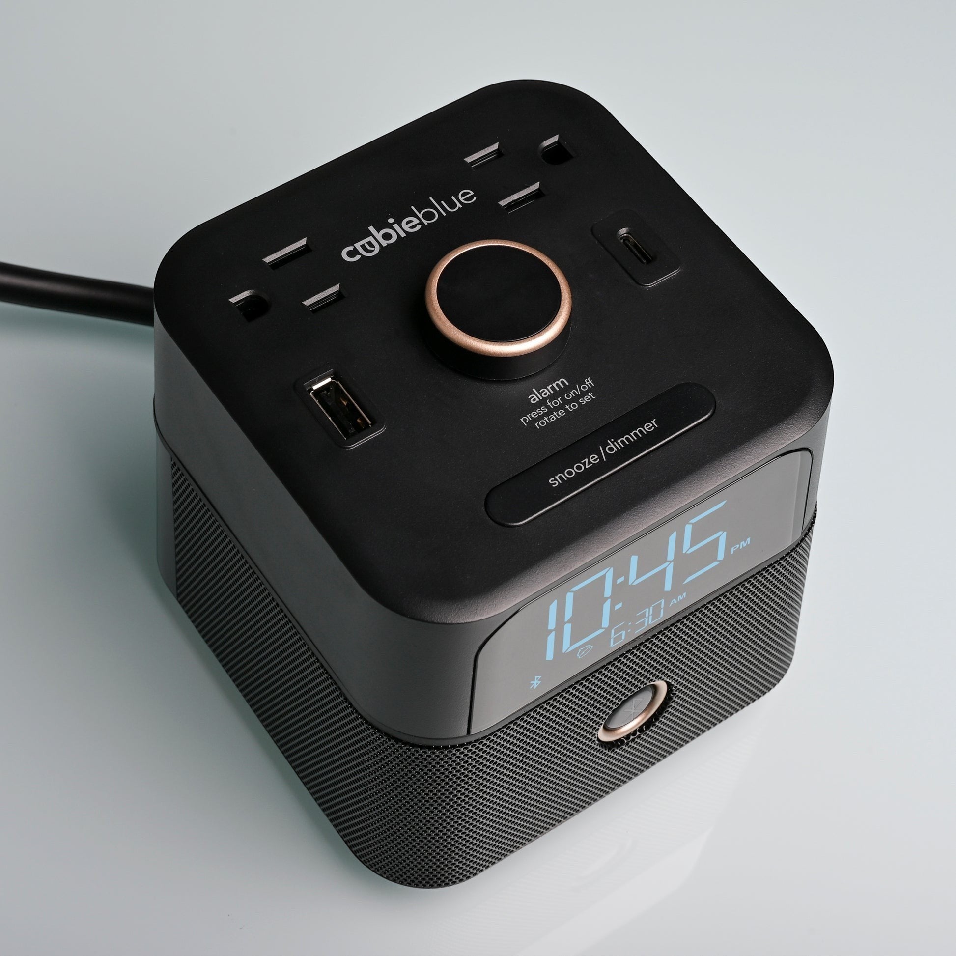 Valiant Products CubieBlue black hotel alarm clock with Bluetooth speaker, USB-C, USB-A ports, and power outlets.
