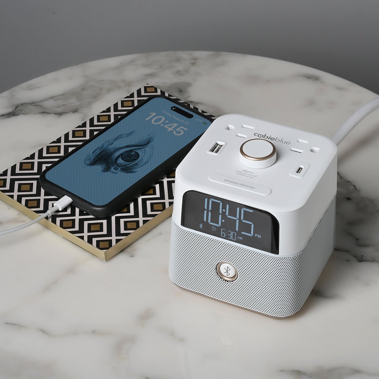 Valiant Products white CubieBlue alarm clock with Bluetooth speaker, USB-C and USB-A ports on a marble table.