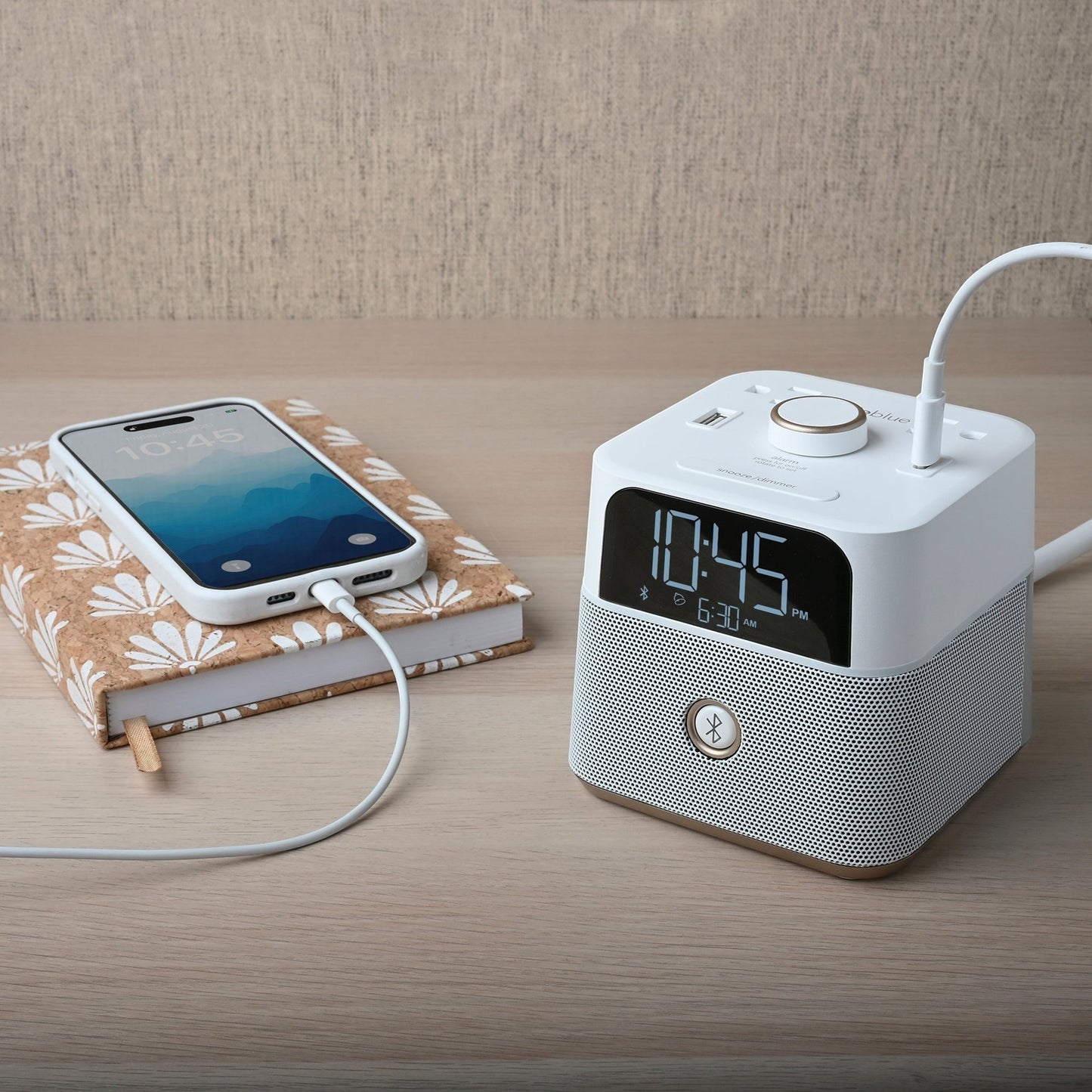 Valiant Products CubieBlue white alarm clock with Bluetooth speaker, USB charging ports, and phone charging on desk