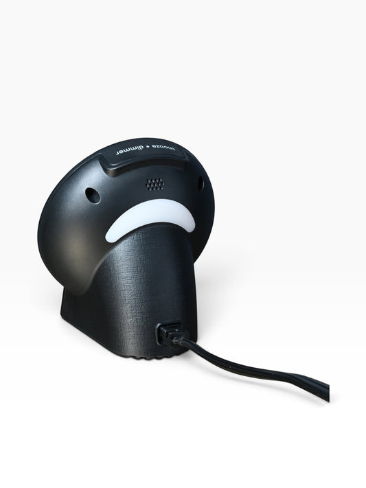 Back view of the black Valiant Products CubieGlow alarm clock showing the power cable and textured finish.