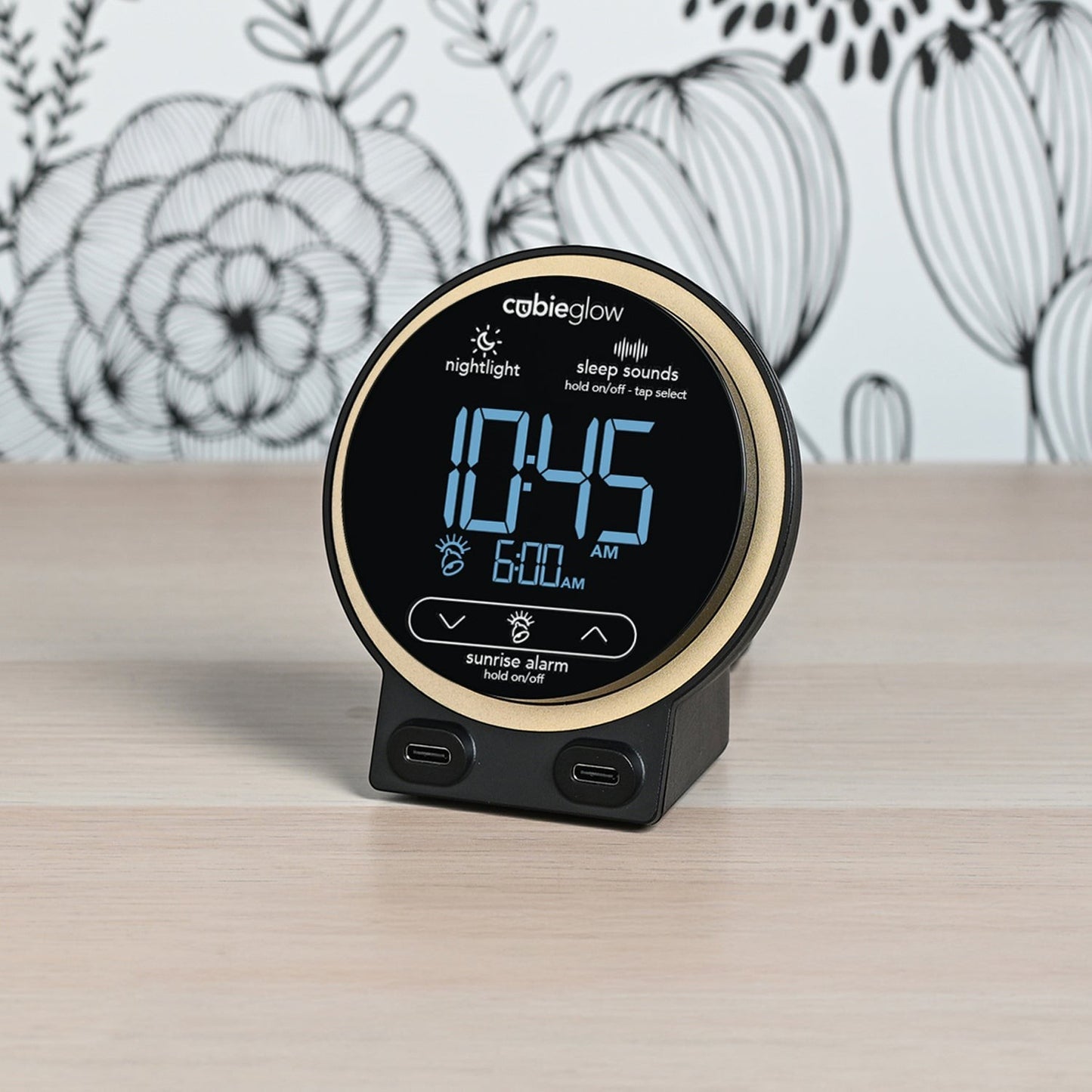 Valiant Products CubieGlow round black and gold alarm clock with digital display and dual USB-C charging ports.