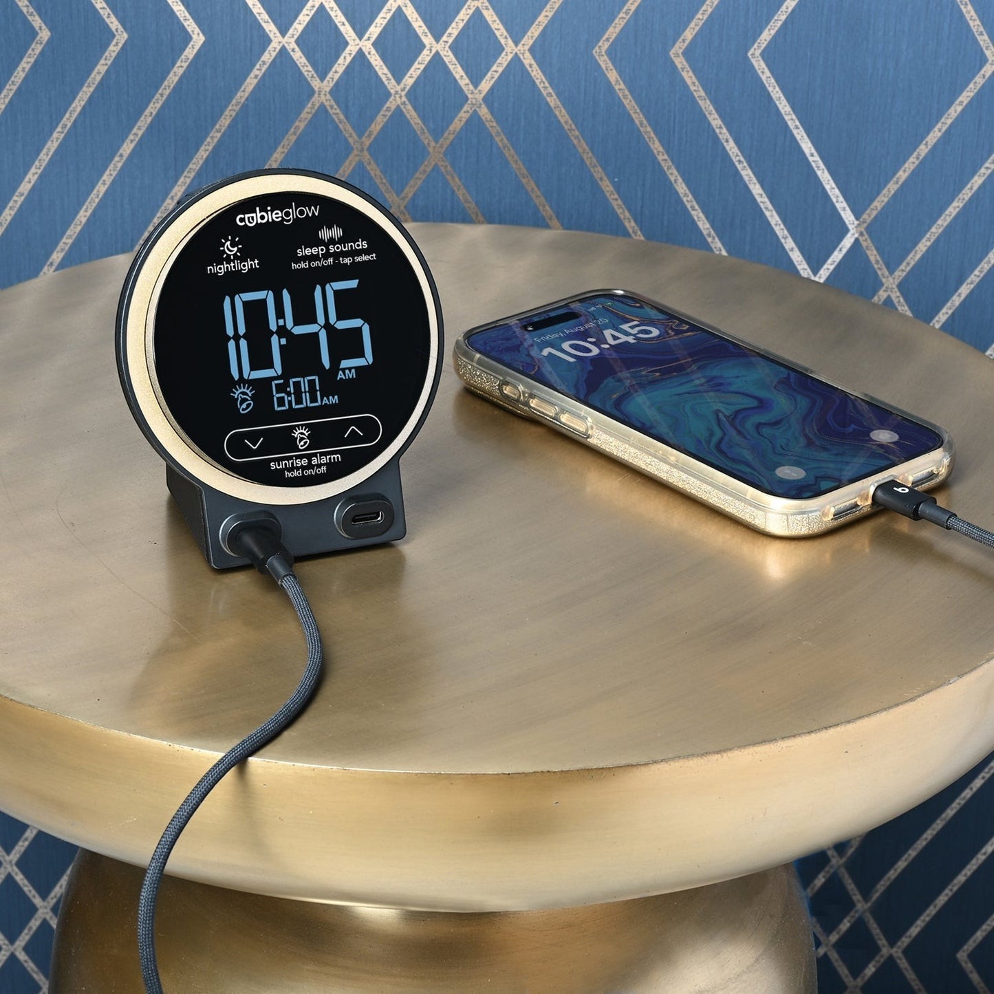 Valiant Products CubieGlow black alarm clock with digital display and USB-C charging ports on a gold side table.