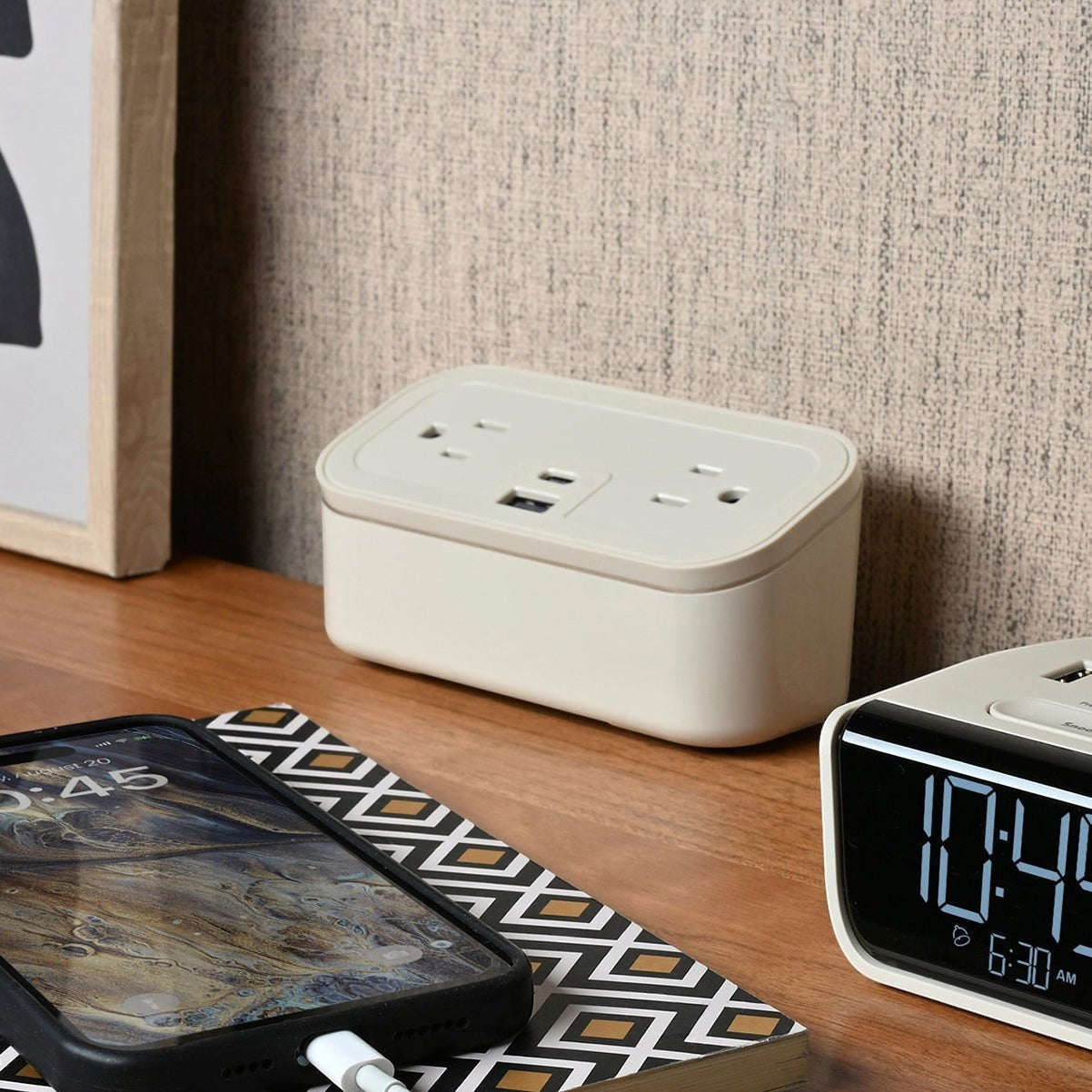 Valiant Products CubieMini latte charging block with power outlets and USB ports on a hotel nightstand