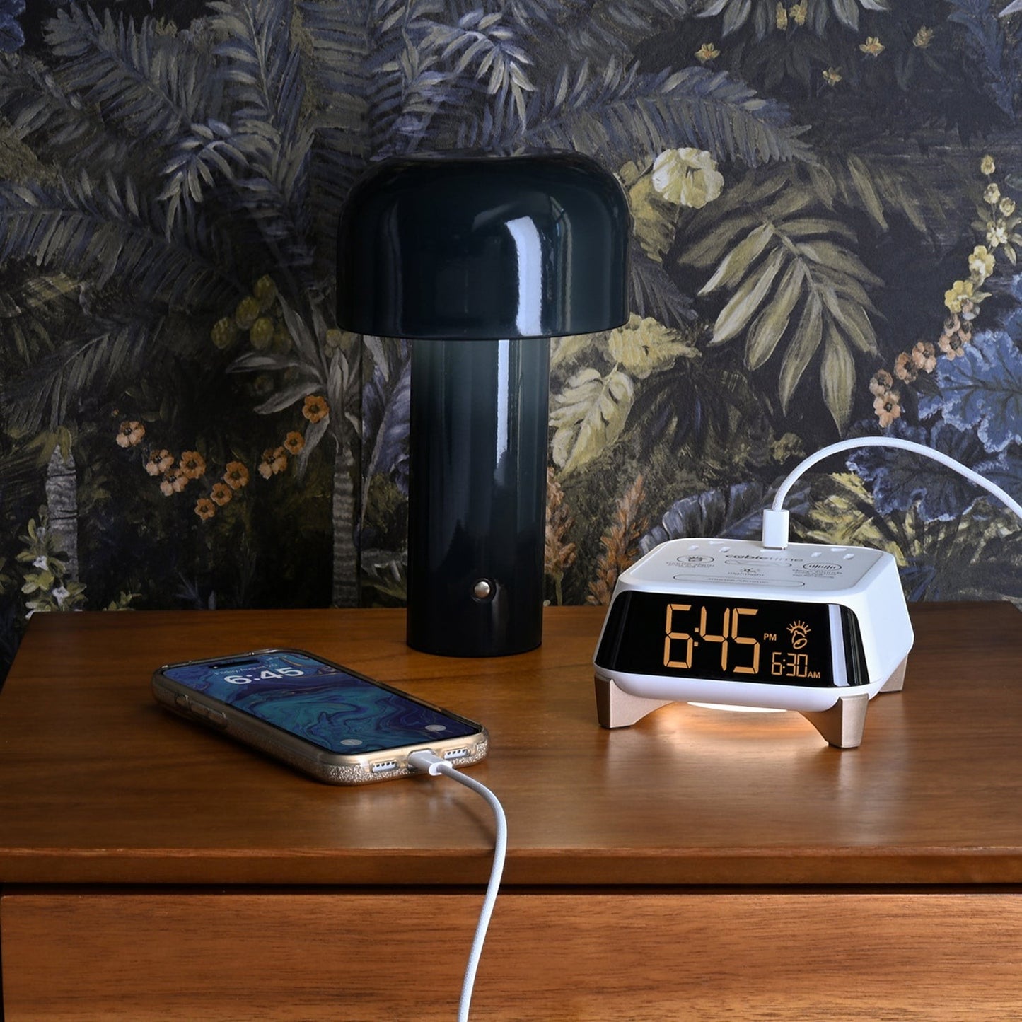 Valiant Products CubieTime Zen white alarm clock with USB charging on a wooden nightstand next to a smartphone.