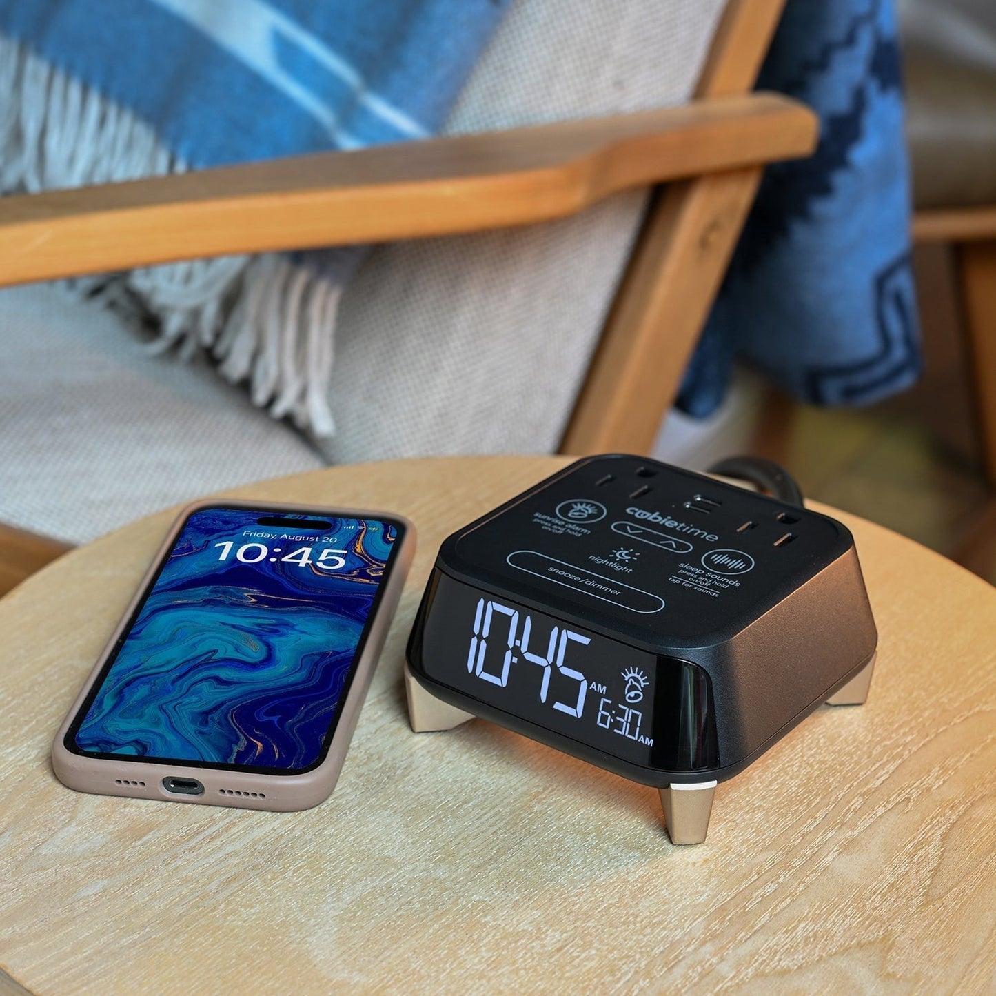 Valiant Products CubieTime Zen black alarm clock with USB charging ports and digital display on a wooden nightstand