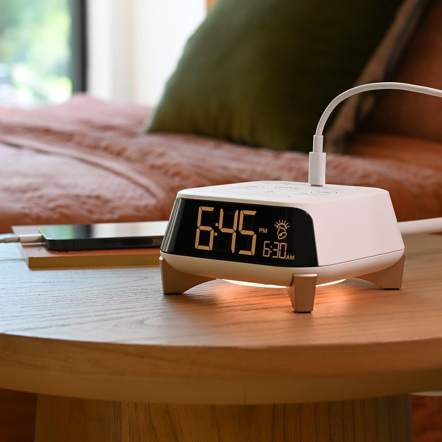 Valiant Products CubieTime Zen white alarm clock with digital display, USB charging, and nightlight on a wooden table.