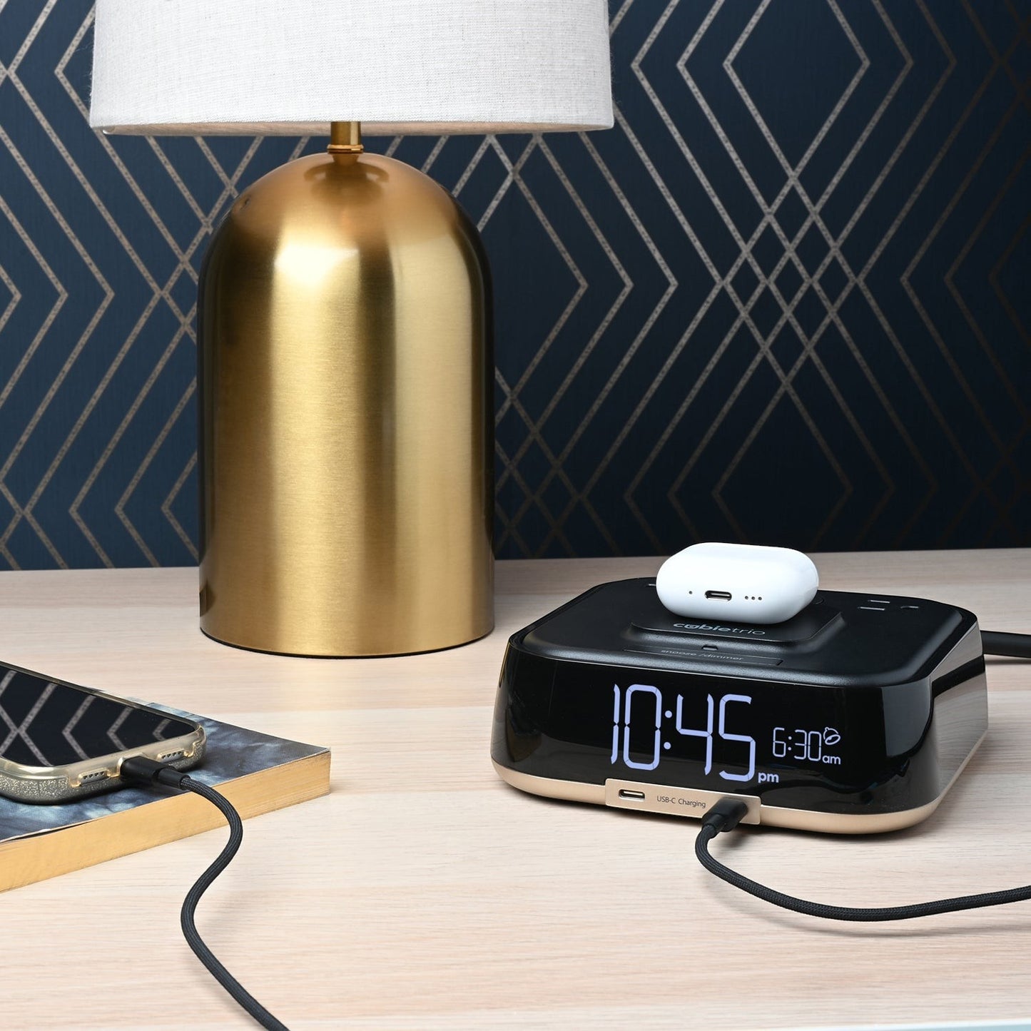 Valiant Products CubieTrio black alarm clock with wireless charging, USB-C ports, and digital display on a nightstand