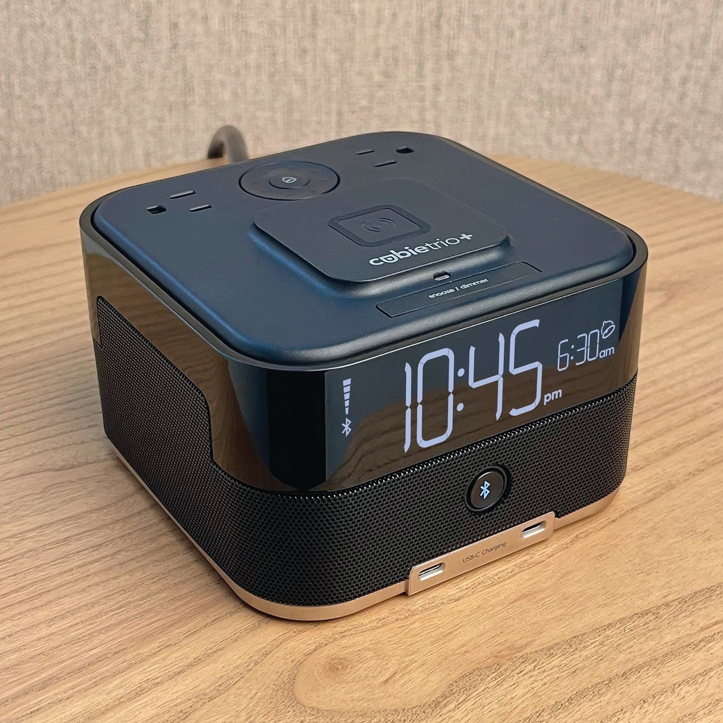 Valiant Products CubieTrio+ black hotel alarm clock with Bluetooth speaker, wireless charging, and USB-C ports.