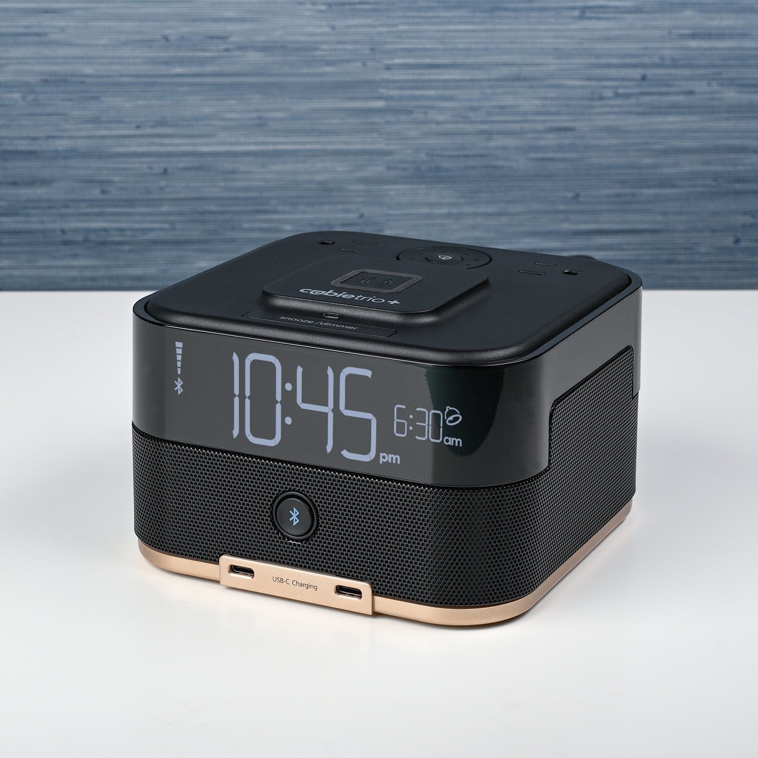 Valiant Products CubieTrio+ black alarm clock with Bluetooth speaker, wireless charging pad, and USB-C ports.