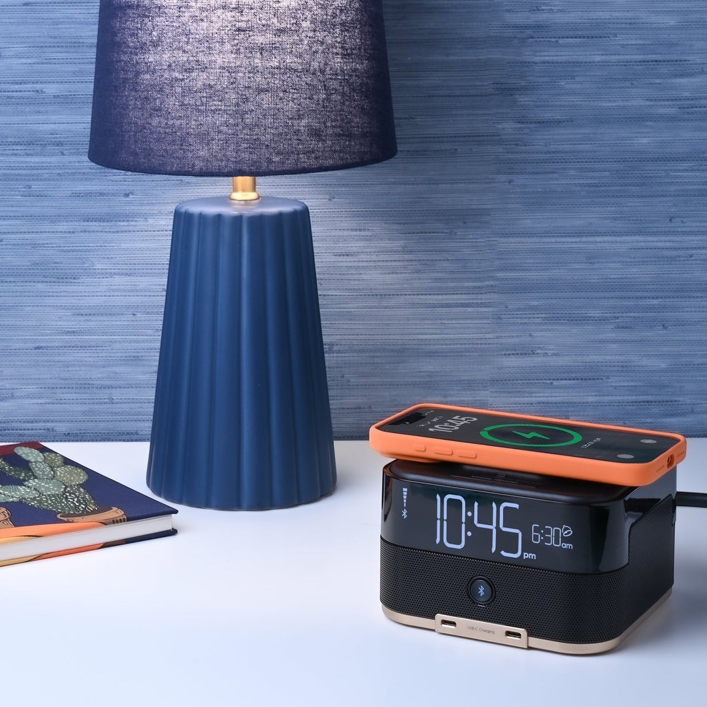 Valiant Products CubieTrio+ black alarm clock with wireless phone charging, Bluetooth speaker, and USB-C ports.