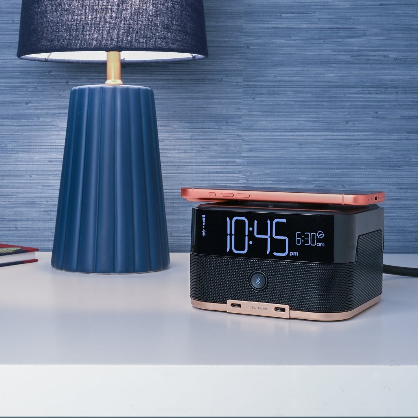 Valiant Products CubieTrio+ black alarm clock with wireless charging, Bluetooth speaker, and USB-C ports on a nightstand