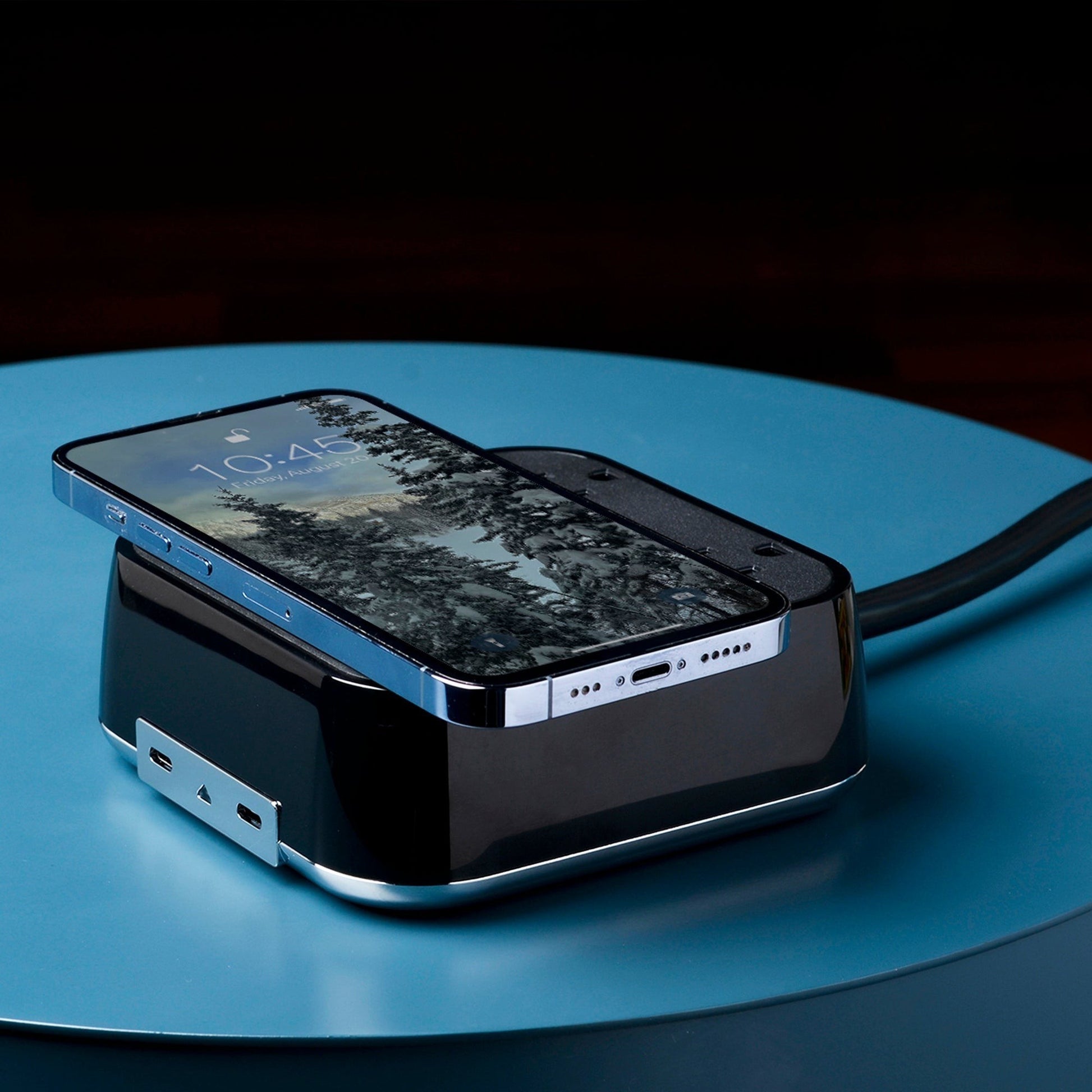 Valiant Products CubieVia black charging block with wireless phone charger, USB-C ports, and AC outlets on a table.