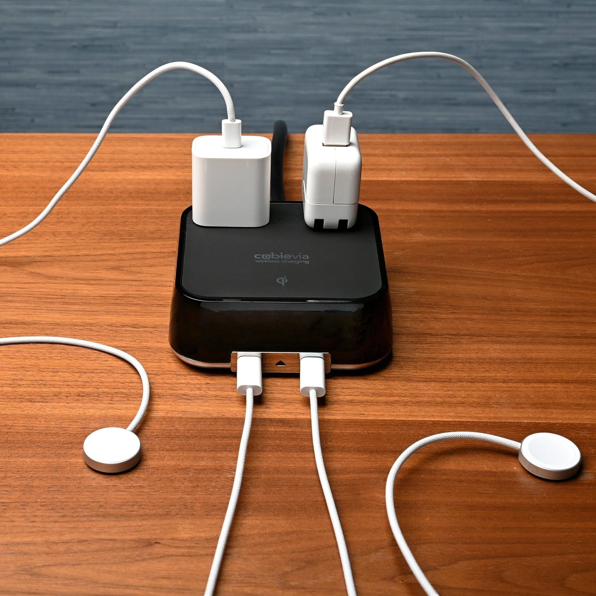 Valiant Products CubieVia black charging block with two AC outlets, two USB-C ports, and wireless charging on a desk