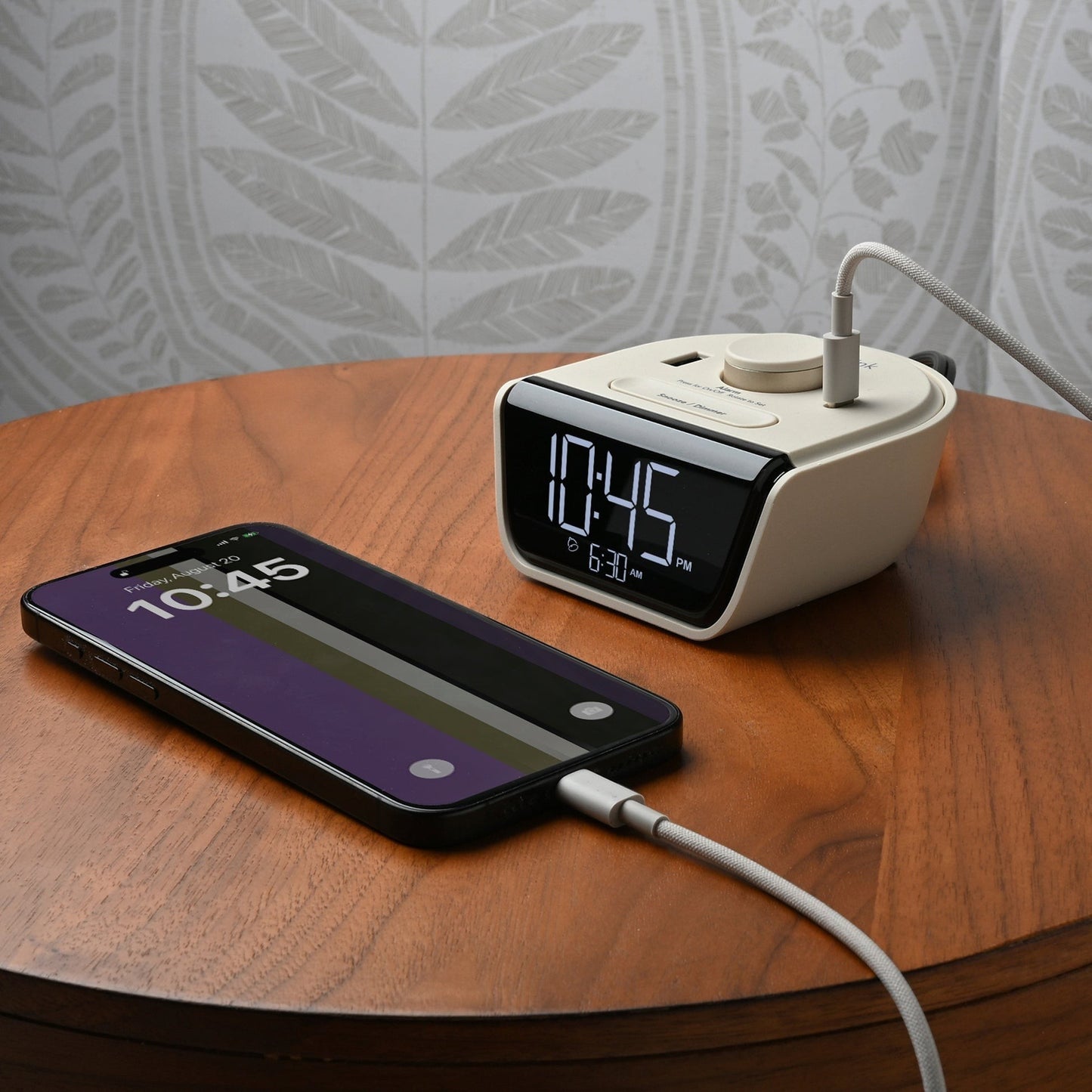 Valiant Products CubieWink latte alarm clock with USB-C and USB-A charging ports on a wooden nightstand with a phone