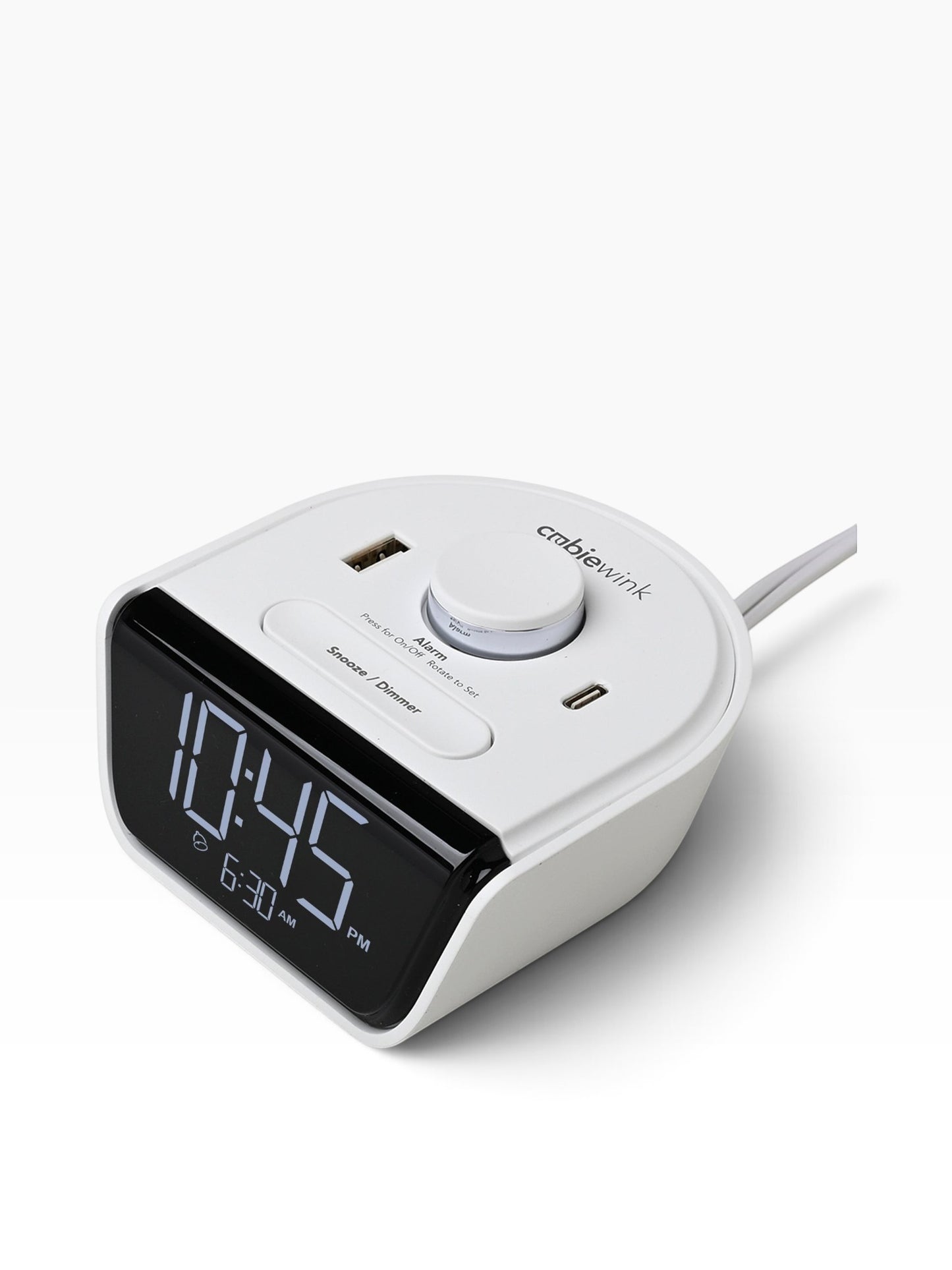 Valiant Products CubieWink white compact alarm clock with USB-A and USB-C charging ports on a nightstand