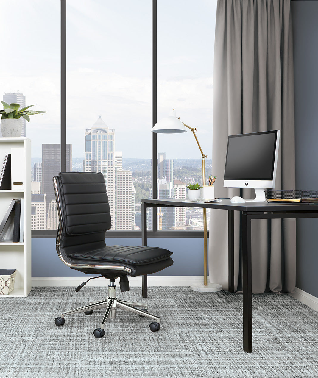 Valiant Products Dione Ergo Chair in black faux leather with chrome base and lumbar support in a modern home office.