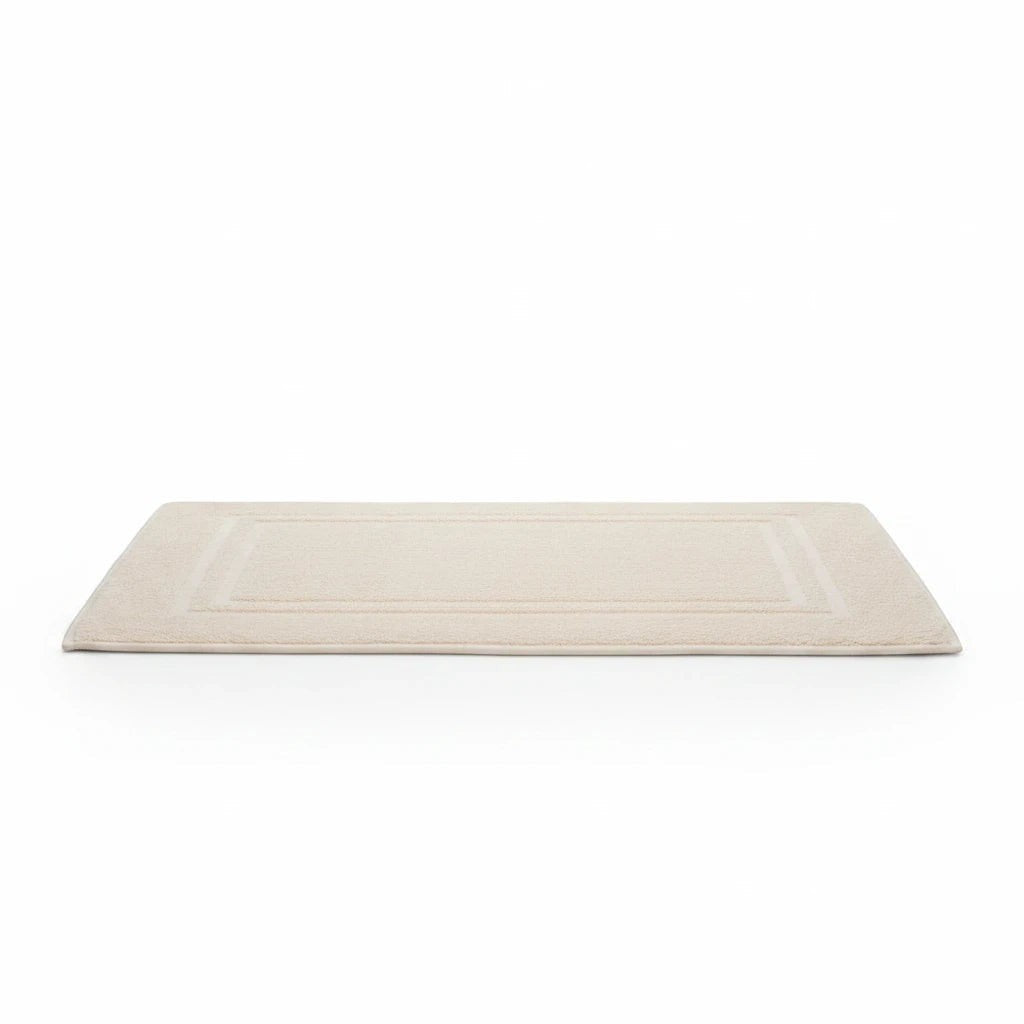 Valiant Products Sovereign ecru bath mat with a traditional dobby border, made from a durable cotton-poly blend.