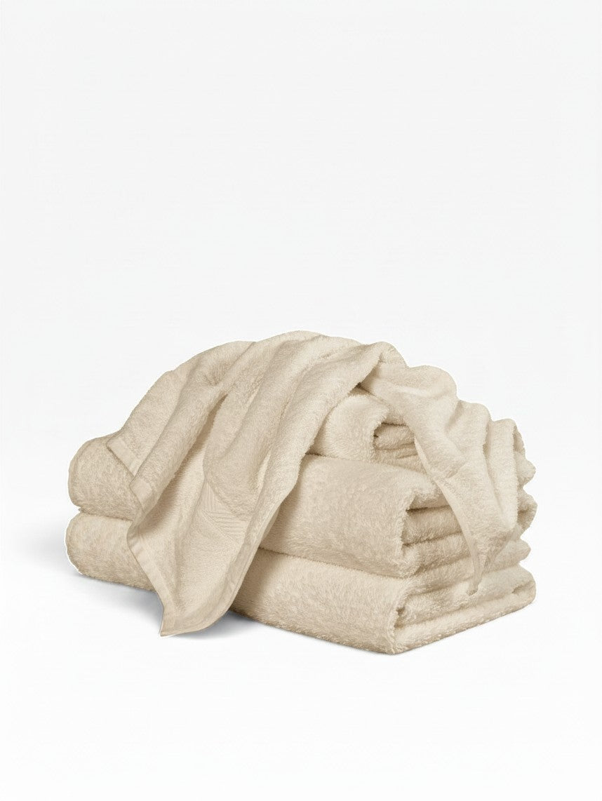 Valiant Products Brentwood ecru cotton washcloths with a classic dobby border design stacked neatly.