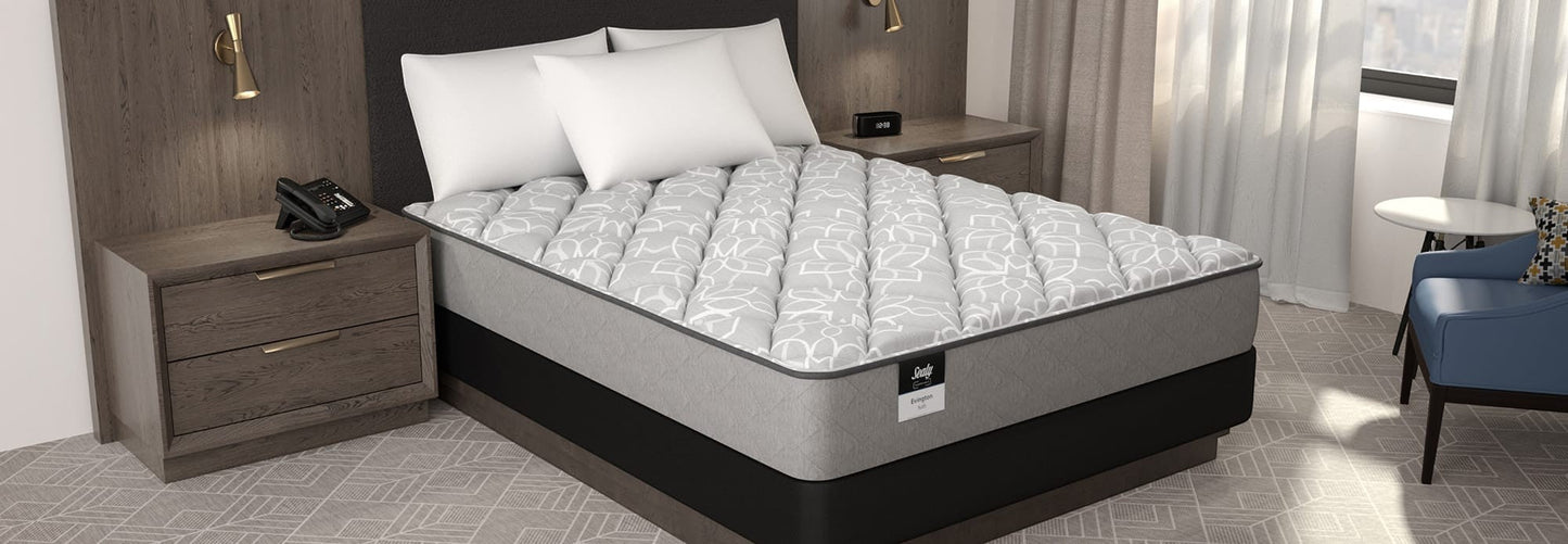 Valiant Products Sealy Evington 12-inch soft tight top mattress with grey patterned fabric in a hotel bedroom.