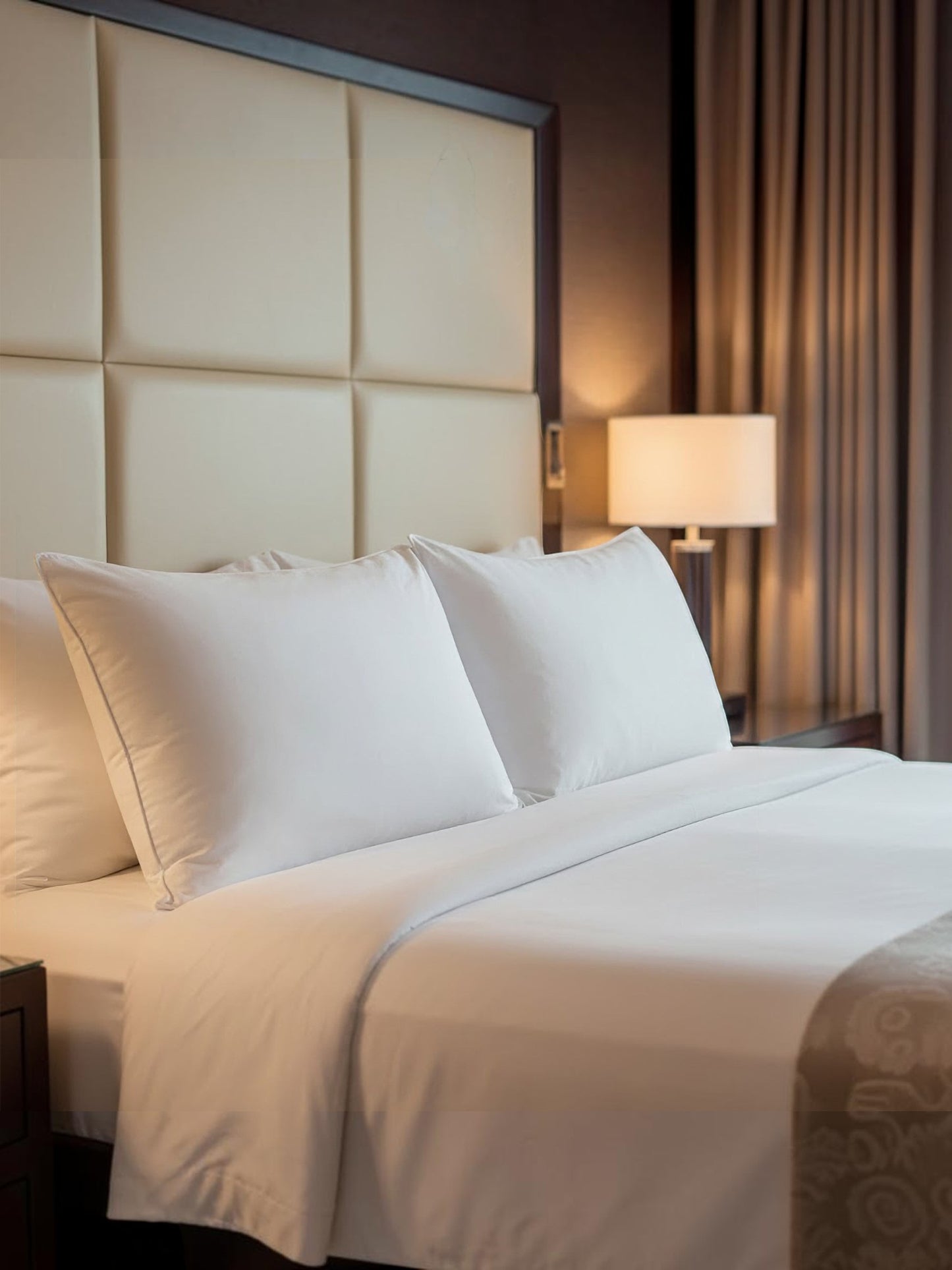 Valiant Products Five Star firm gel pillows in white on a luxury hotel bed with piped cord edges.