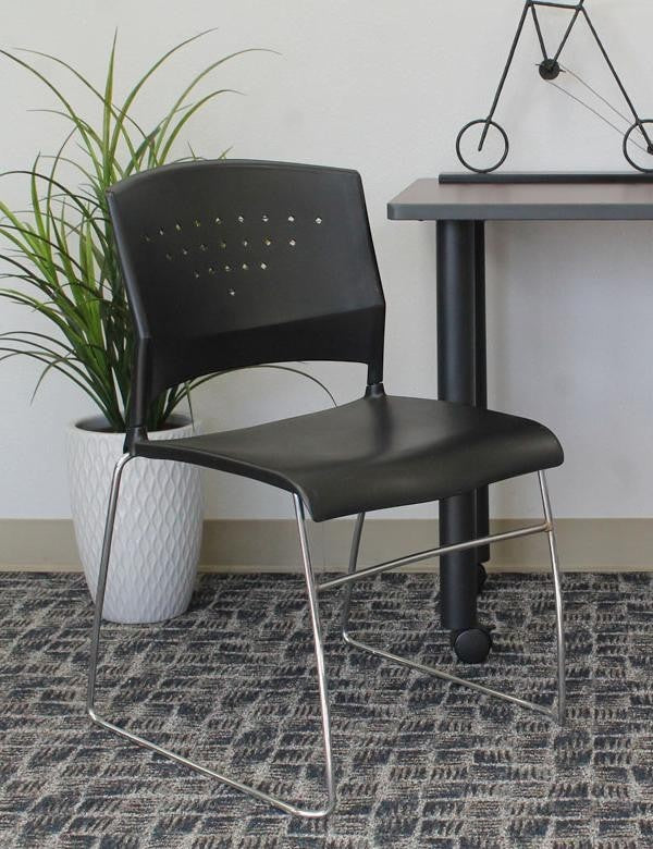 Valiant Products Kellan black polypropylene stack chair with a durable chrome frame and sculpted backrest.