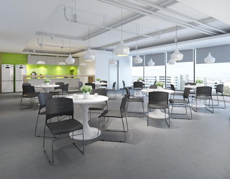 Valiant Products Kellan black polypropylene stackable chairs with chrome frames arranged in a modern office breakroom.