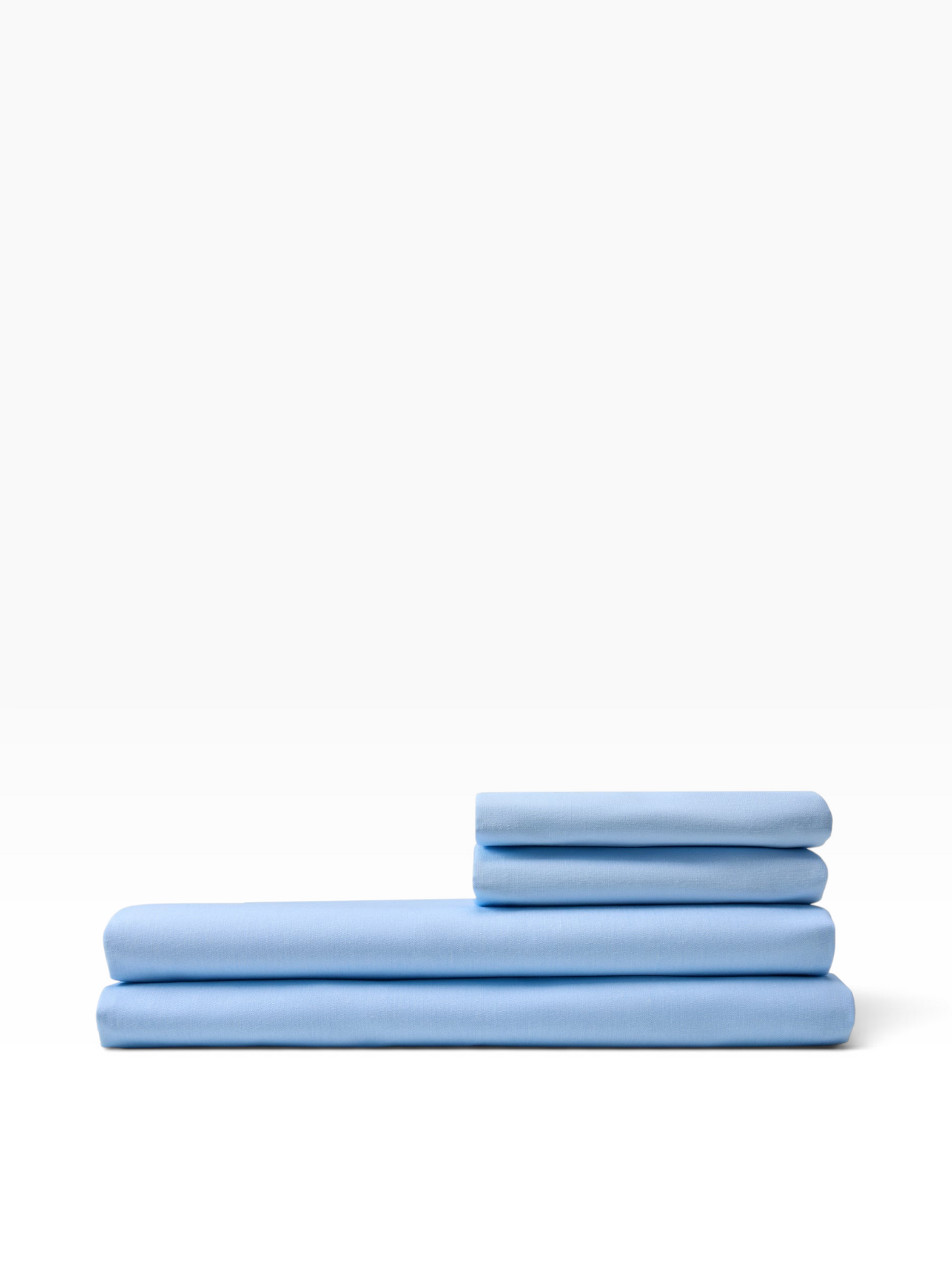 Valiant Products light blue T-180 percale flat sheets folded in a neat stack, made from a durable cotton-poly blend.