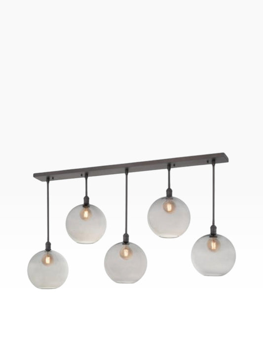 Valiant Products Luma pendant light featuring five smoked grey glass globe shades on a bronze linear fixture.