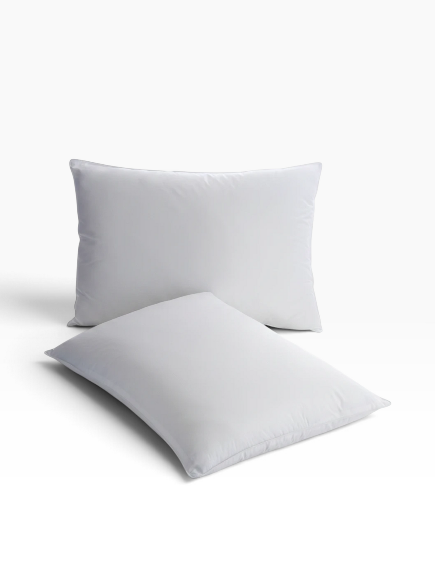 Two white Martex Basics Pillows from Valiant Products with a smooth cotton-polyester blend cover.
