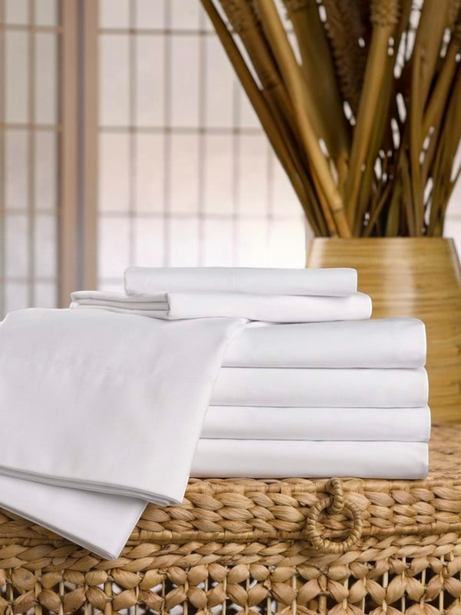 Valiant Products Martex Ultra Touch Suites white brushed microfiber pillowcases stacked on a woven basket